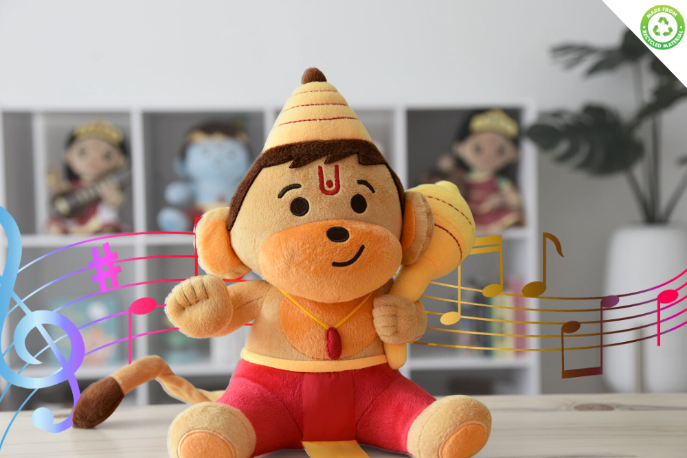 A plush toy depicting Baby Hanuman, holding a mace, with a flexible tail attached, sitting against a backdrop of various toy figures.