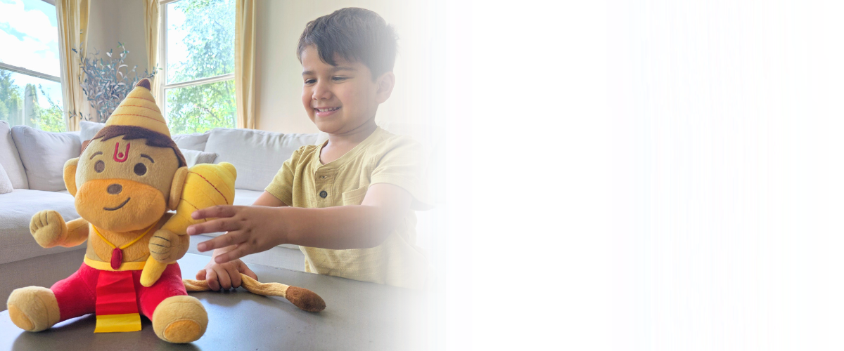Child playing with a Hanuman plush toy in a bright room